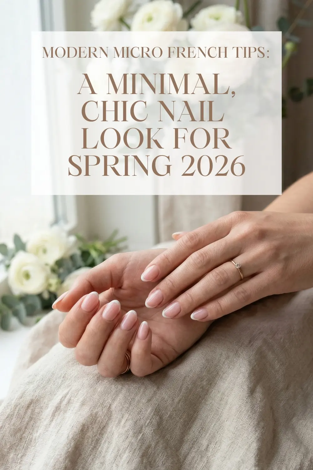 Modern micro French tips on short almond nails with thin white lines and milky pink base for Spring 2026